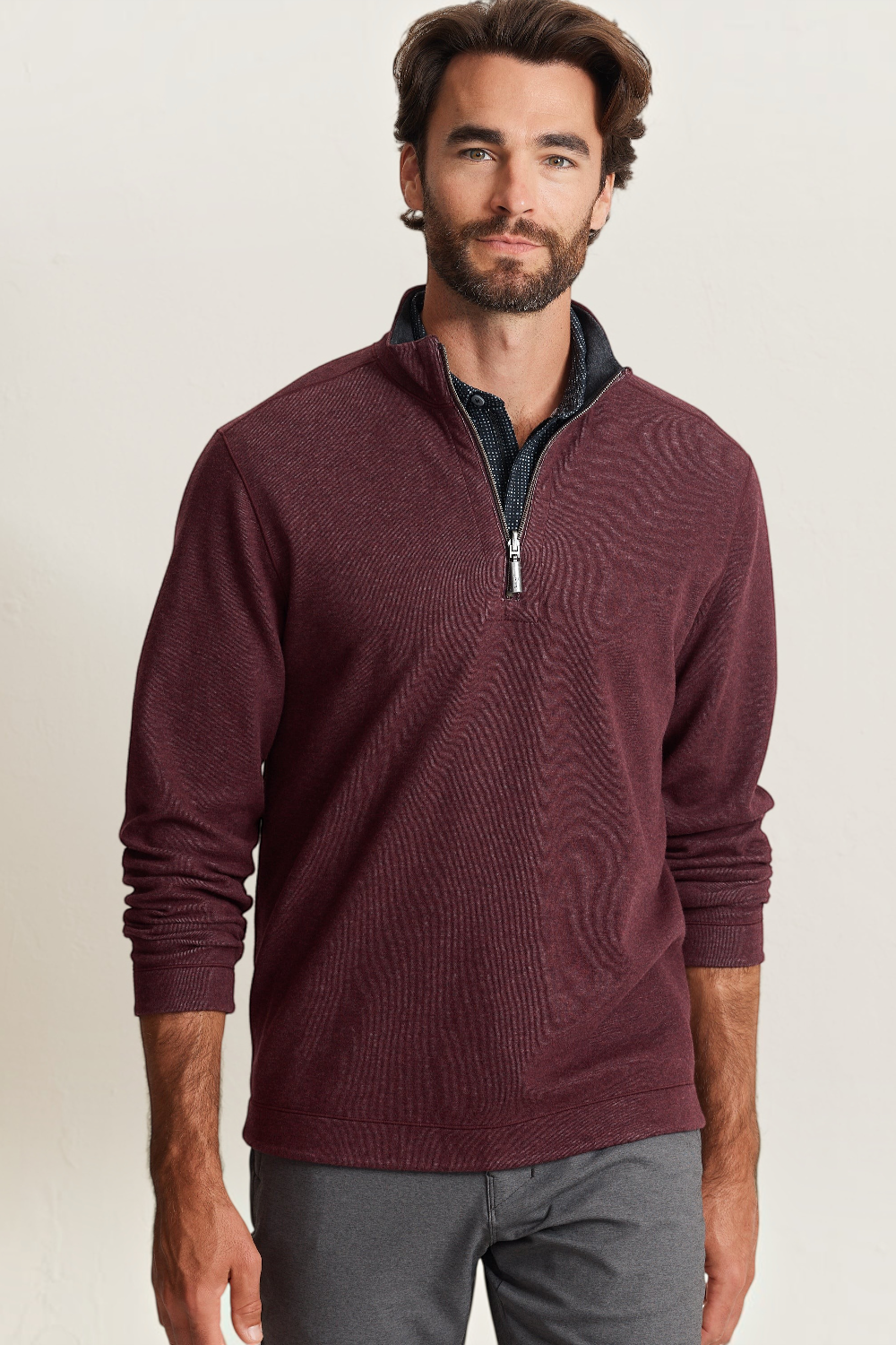 Broderick's Clothing Co. model wearing a black cherry reversible half-zip sweater with a dark patterned collar.