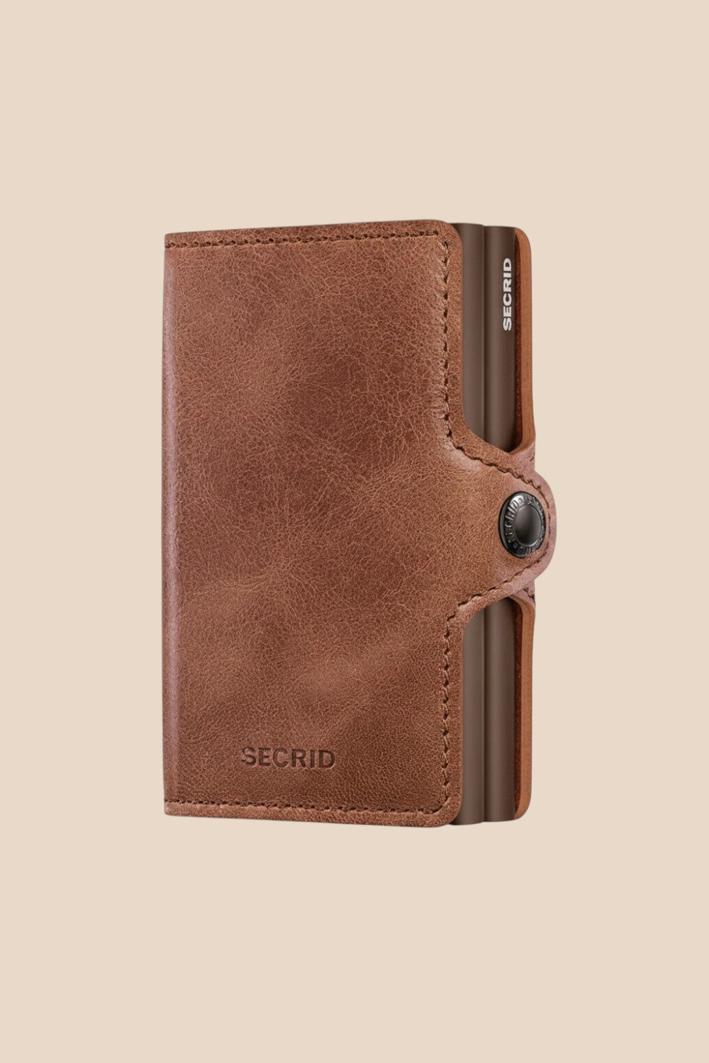 Broderick's Clothing Co. Secrid Twinwallet in vintage cognac-brown leather with a secure snap button closure.