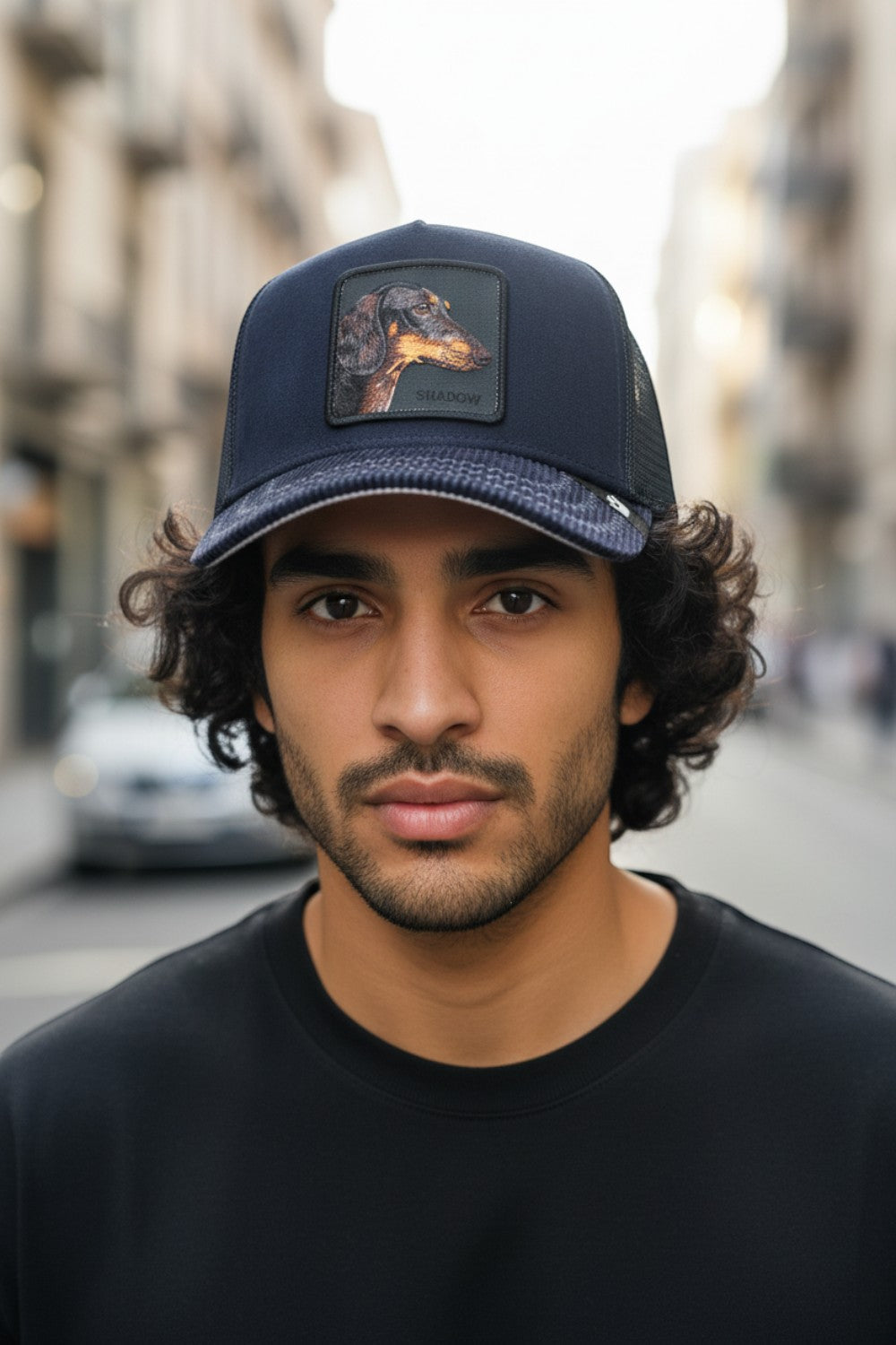 Broderick's Clothing Co. Goorin Bros. SHADOW REMIX navy trucker hat with a dachshund patch worn by a young man.