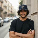 Broderick's Clothing Co. Goorin Bros. SHADOW REMIX navy trucker hat with animal patch worn by a man in a black t-shirt