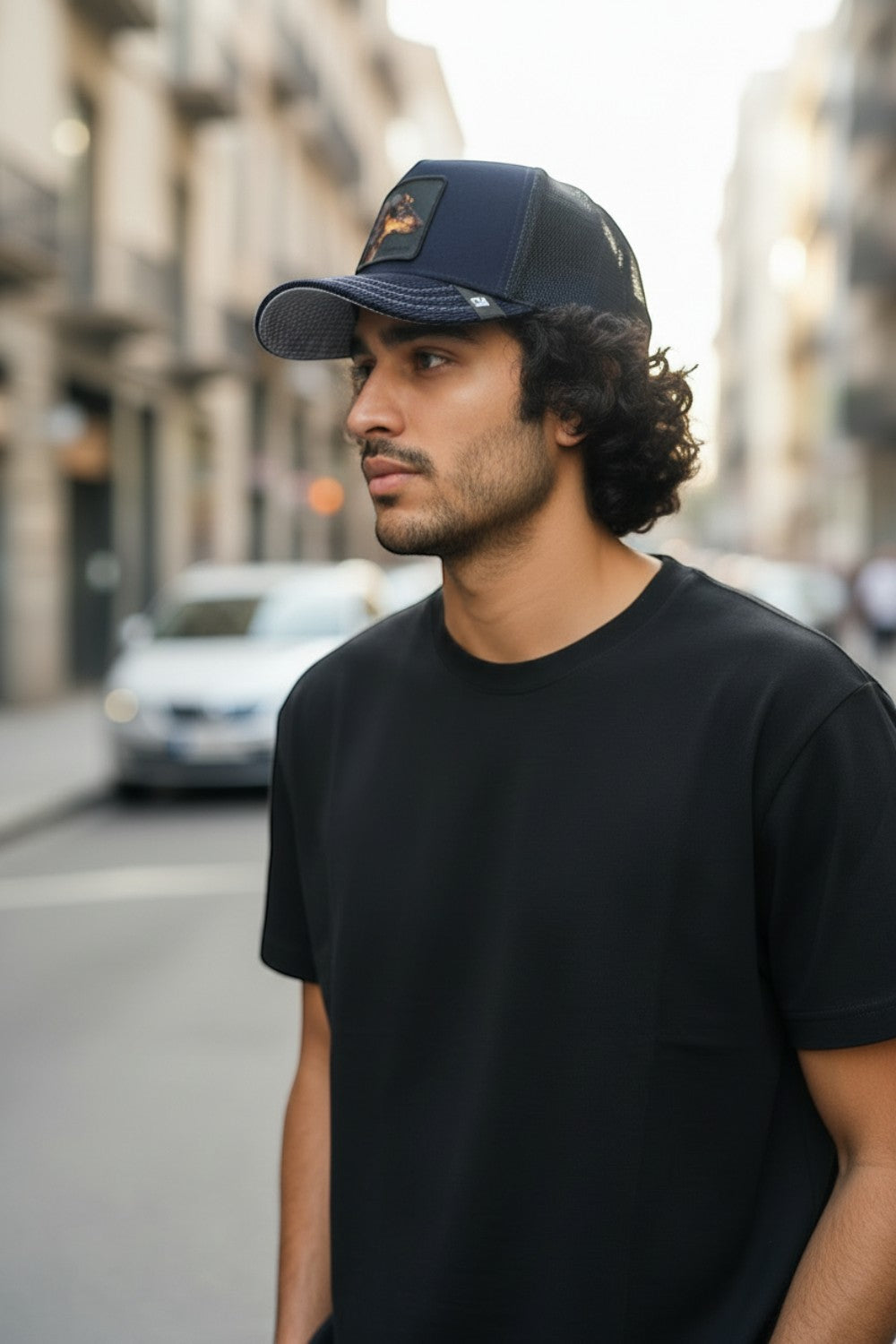 Broderick's Clothing Co. Goorin Bros. SHADOW REMIX navy blue trucker hat with animal patch worn by a man outdoors