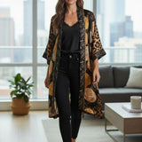 Broderick's Clothing Co. Shannon Passero Dylan kimono cardigan in black and gold leopard print with circular motifs.