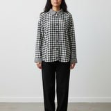 Model wearing Broderick's Clothing Co. Shannon Passero Aubrey black and white gingham button-down shirt with trousers.