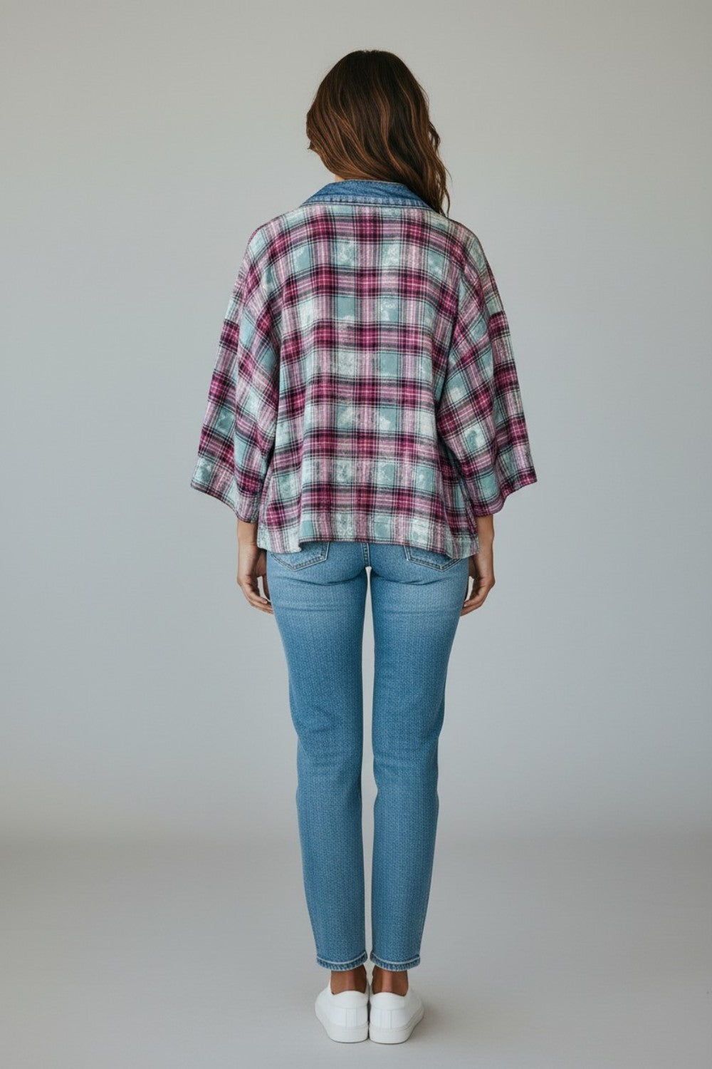 Back view of a woman wearing a Broderick's Clothing Co. Shannon Passero Ruthie plaid cardigan with denim collar.