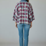 Back view of a woman wearing a Broderick's Clothing Co. Shannon Passero Ruthie plaid cardigan with denim collar.