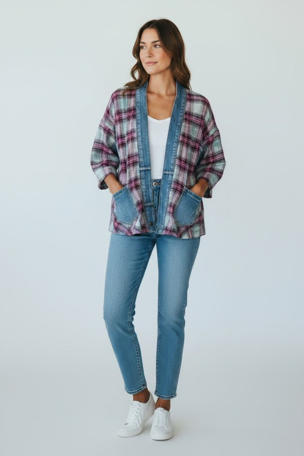 Model wearing a Broderick's Clothing Co. Shannon Passero Ruthie plaid cardigan with denim trim and front pockets.