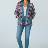 Model wearing a Broderick's Clothing Co. Shannon Passero Ruthie plaid cardigan with denim trim and front pockets.