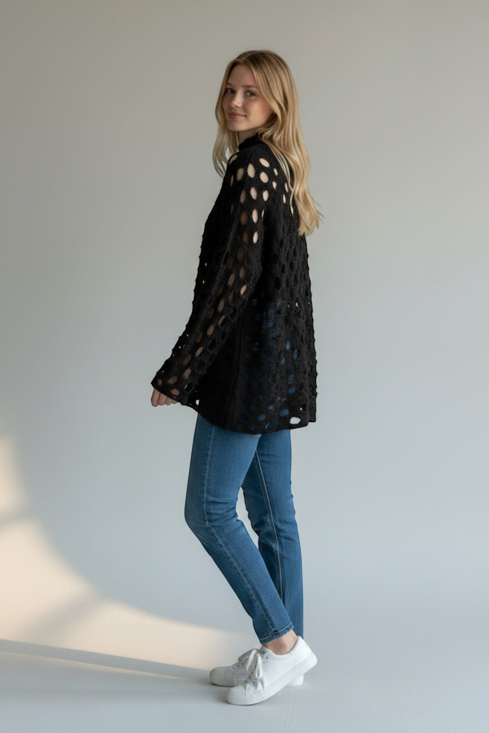 Broderick's Clothing Co. Shannon Passero Tara black open-knit pullover sweater with circular cutouts on a model