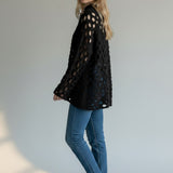 Broderick's Clothing Co. Shannon Passero Tara black open-knit pullover sweater with circular cutouts on a model