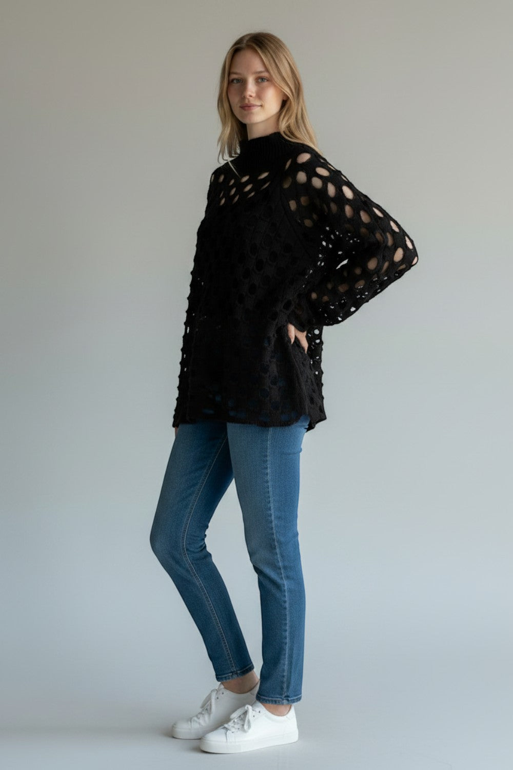 Broderick's Clothing Co. Shannon Passero Tara black open-knit high-neck sweater with circular cutouts on a model