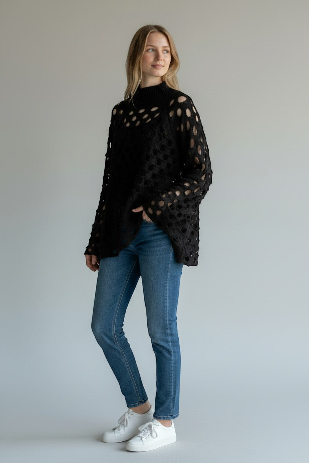 Broderick's Clothing Co. Shannon Passero Tara black open-knit high-neck sweater with circular cutouts on a model.