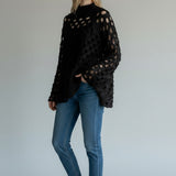 Broderick's Clothing Co. Shannon Passero Tara black open-knit high-neck sweater with circular cutouts on a model.