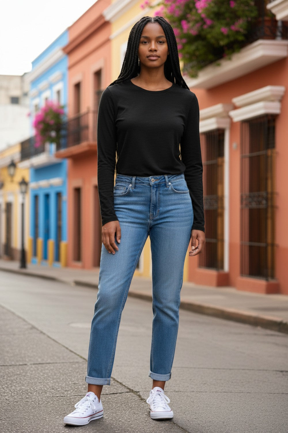 Model wearing a black long-sleeve Shannon Passero Zoya Top from Broderick's Clothing Co. with blue jeans and sneakers.