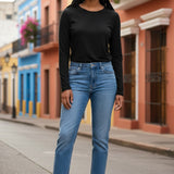 Model wearing a black long-sleeve Shannon Passero Zoya Top from Broderick's Clothing Co. with blue jeans and sneakers.