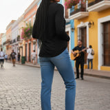 Broderick's Clothing Co. Shannon Passero Zoya black long-sleeve top worn with blue jeans on a vibrant city street