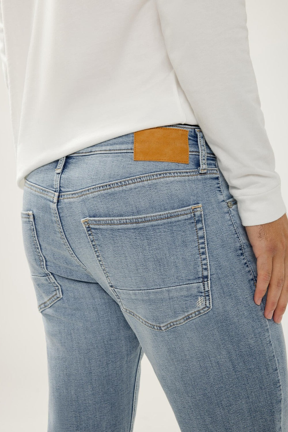 Broderick's Clothing Co. Silver Jeans Co. Machray light wash slim straight knit flex jeans with tan leather back patch