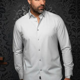 Broderick's Clothing Co. Au Noir Alexander silver long sleeve knit dress shirt worn by a man against a damask wall