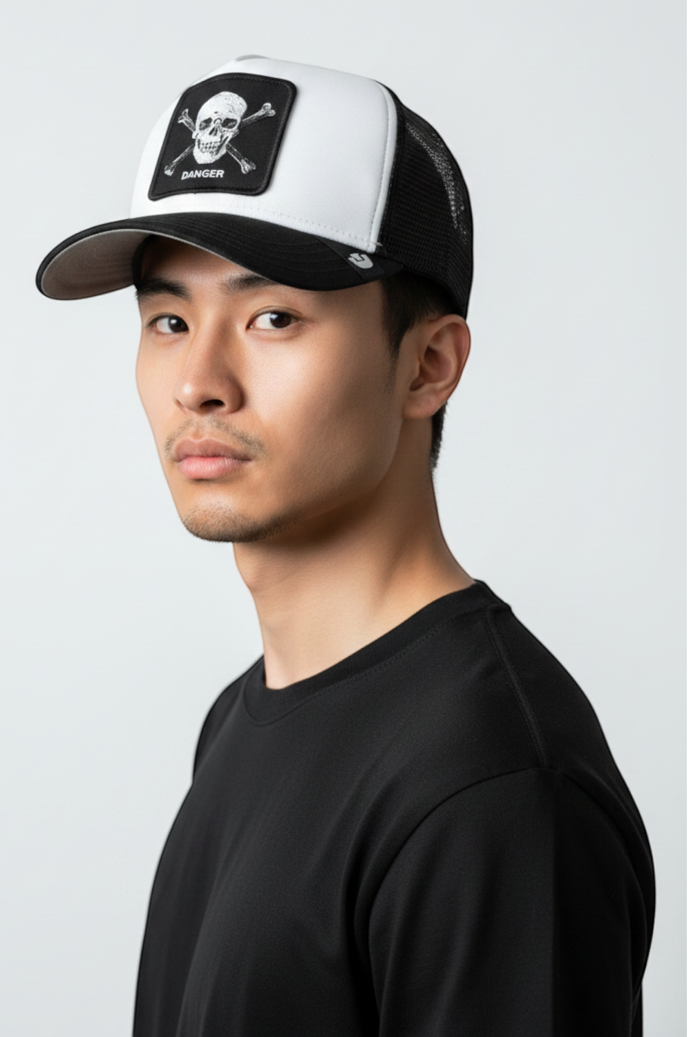 Broderick's Clothing Co. Goorin Bros. black and white trucker hat with skull and crossbones patch on a male model