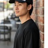 Man wearing a Broderick's Clothing Co. black and white trucker hat with a skull and crossbones patch