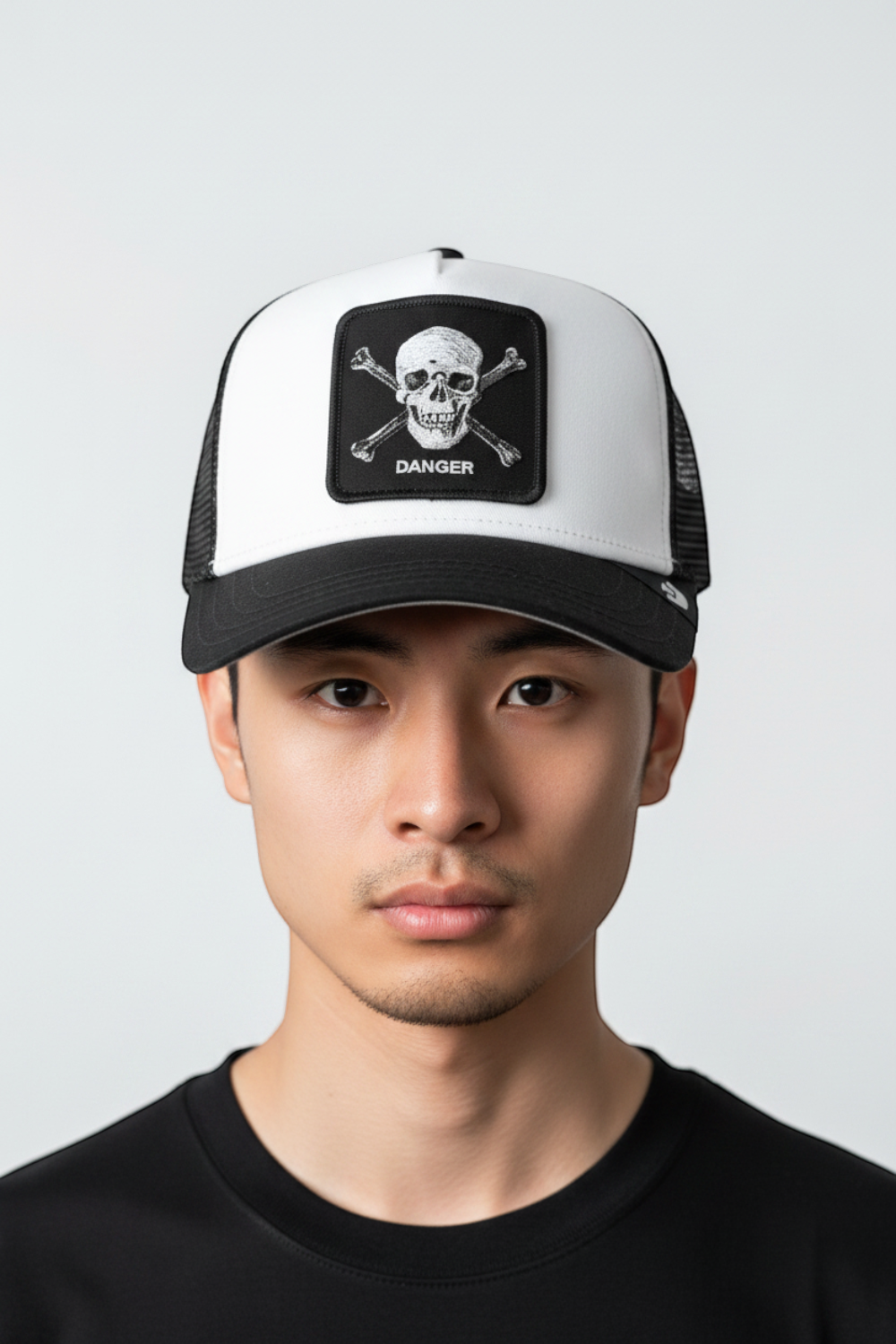 Broderick's Clothing Co. Goorin Bros. black and white trucker hat with skull and crossbones patch on a man