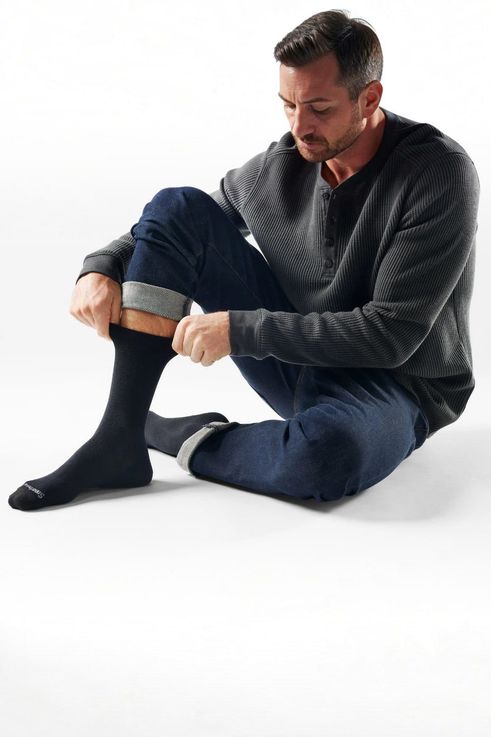 Man wearing Broderick's Clothing Co. Smartwool Everyday Anchor Line black crew socks with jeans and a waffle henley