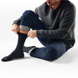 Man wearing Broderick's Clothing Co. Smartwool Everyday Anchor Line black crew socks with jeans and a waffle henley