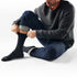 Man wearing Broderick's Clothing Co. Smartwool Everyday Anchor Line black crew socks with jeans and a waffle henley