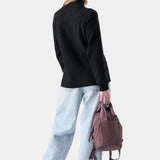 Broderick's Clothing Co. Smartwool women's black speckled knit tunic sweater worn with light wash jeans and a beanie.