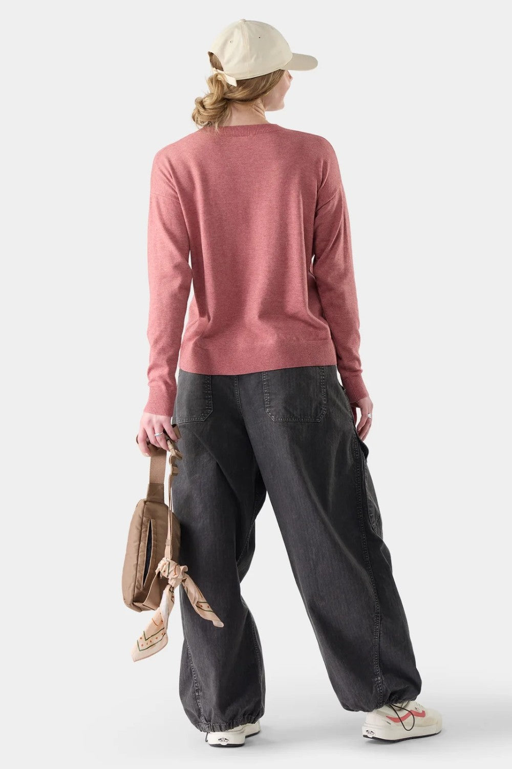 Broderick's Clothing Co. Smartwool Edgewood crew sweater in dusty rose worn by a woman with a cap and dark trousers