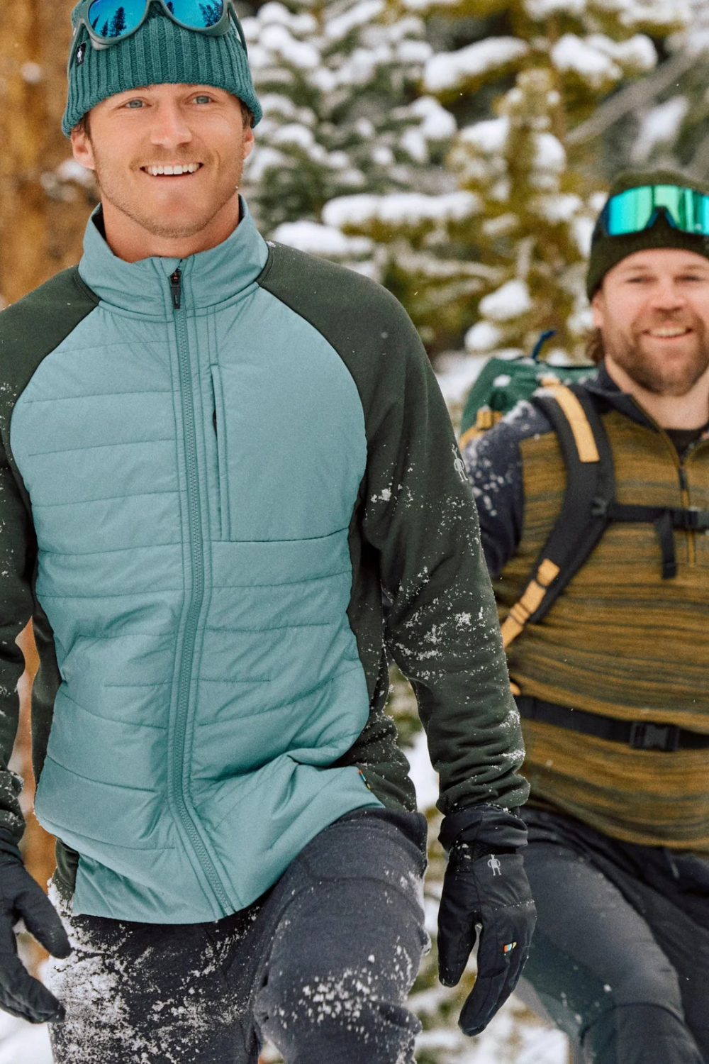 Broderick's Clothing Co. Smartwool Smartloft gloves on a man hiking in snowy mountains with touchscreen-compatible tips