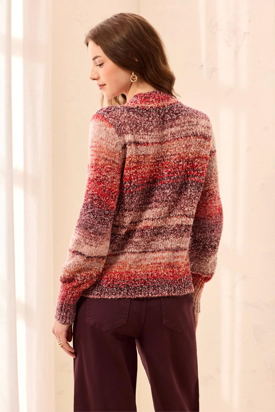 Broderick's Clothing Co. mock neck sweater in a sunset-hued space-dye textured knit worn by a woman from behind.