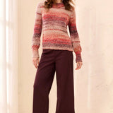 Model wearing a Broderick's Clothing Co. sunset-hued space-dye mock neck sweater with a textured knit finish.