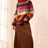 Broderick's Clothing Co. multi-colored striped bouclé turtleneck sweater worn with a brown pleated midi skirt