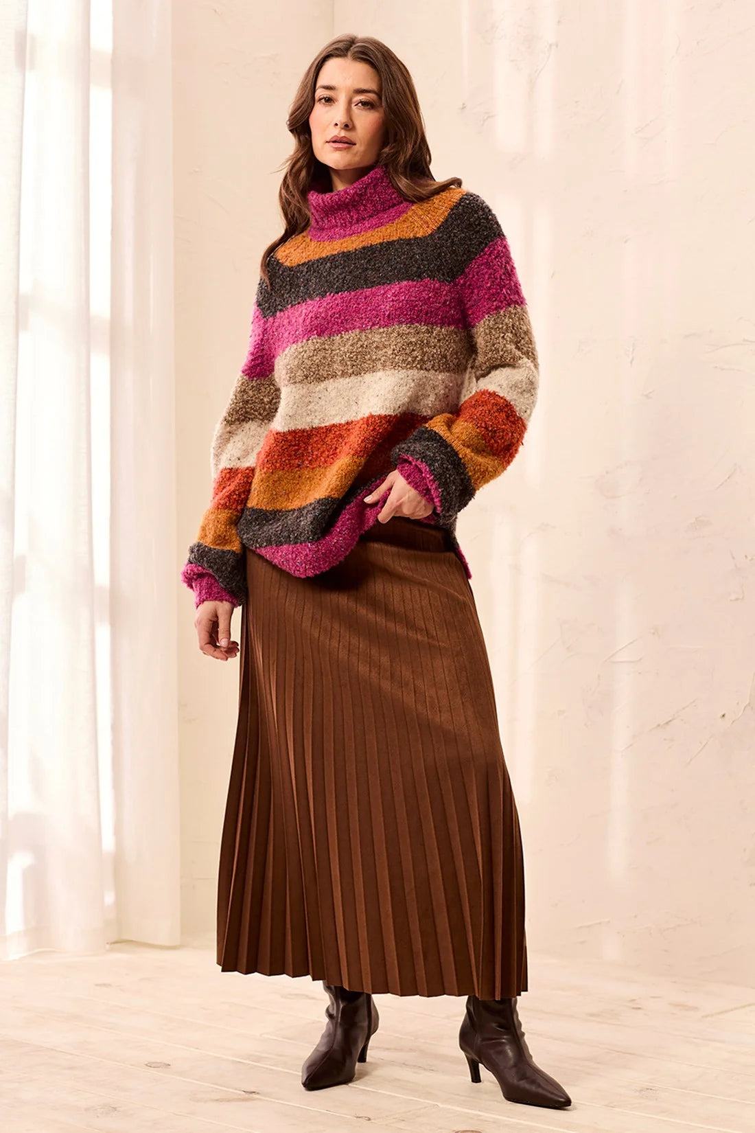 Broderick's Clothing Co. multi-colored striped bouclé turtleneck sweater worn with a brown pleated midi skirt