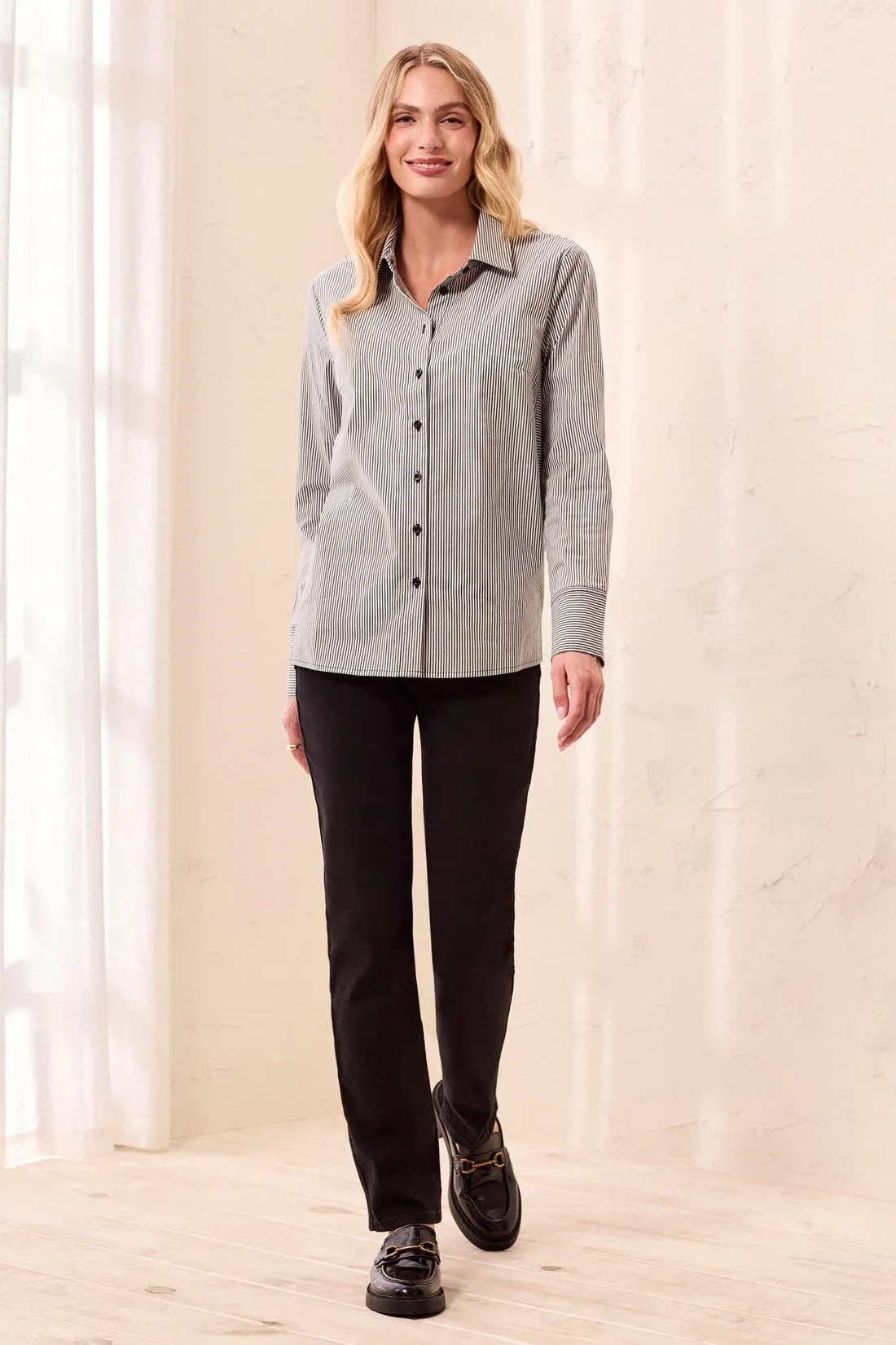 Model wearing a Broderick's Clothing Co. striped button-front shirt with wide cuffs and black trousers
