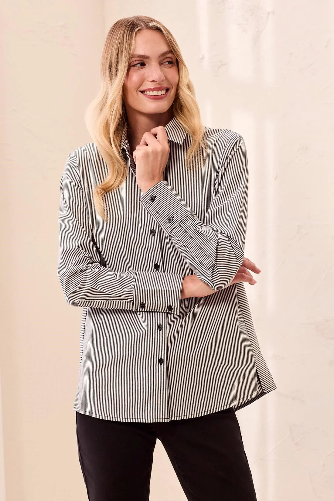 Broderick's Clothing Co. striped button-front shirt with wide cuffs and side panels on a smiling blonde model.