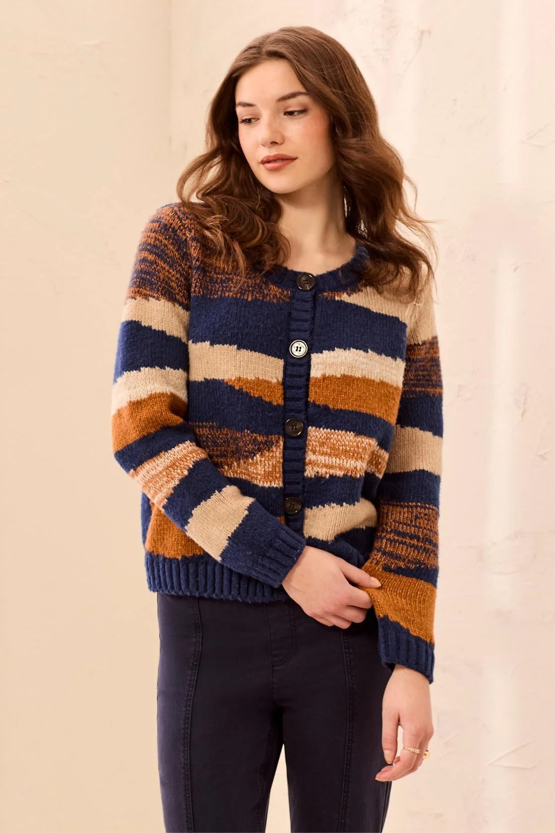 Broderick's Clothing Co. crew neck cardigan in a multi-tonal navy, rust, and beige stripe soft-touch knit design.