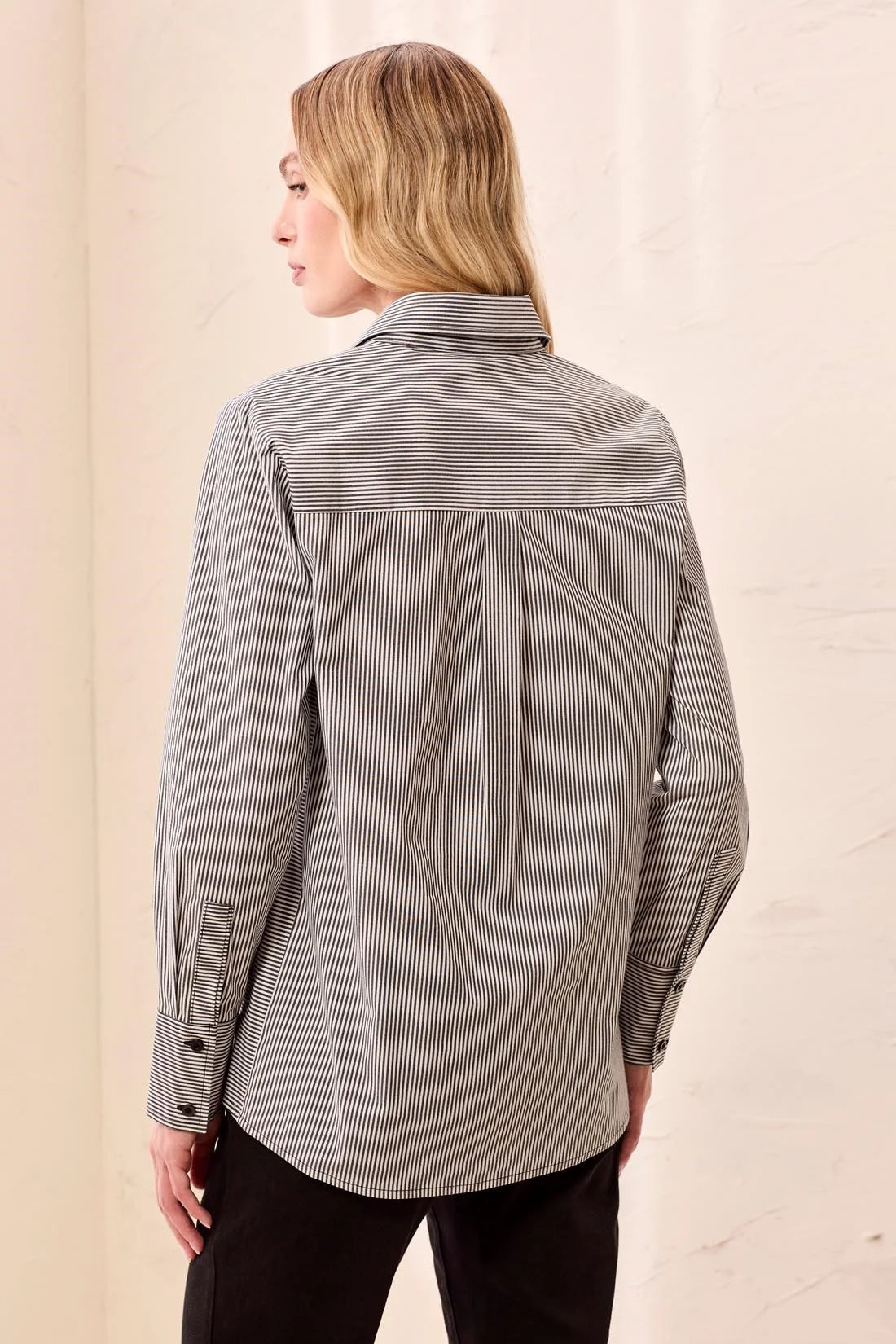 Broderick's Clothing Co. striped button-front shirt with long sleeves and wide cuffs, back view on a blonde model.