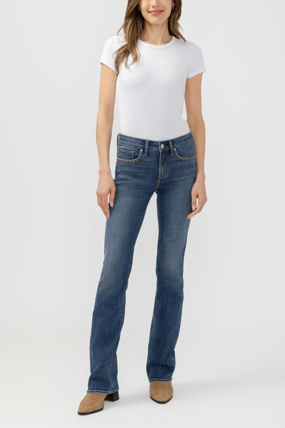 Broderick's Clothing Co. Silver Jeans Co. Suki mid-rise slim bootcut jeans in medium wash denim with pocket studs.
