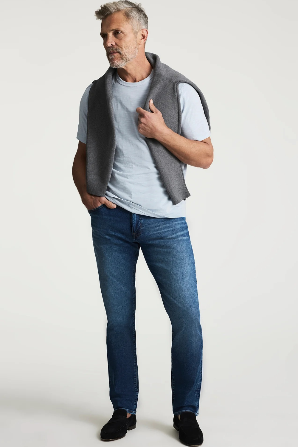 Broderick's Clothing Co. 34 Heritage medium blue tapered leg jeans with contrast stitching on a male model