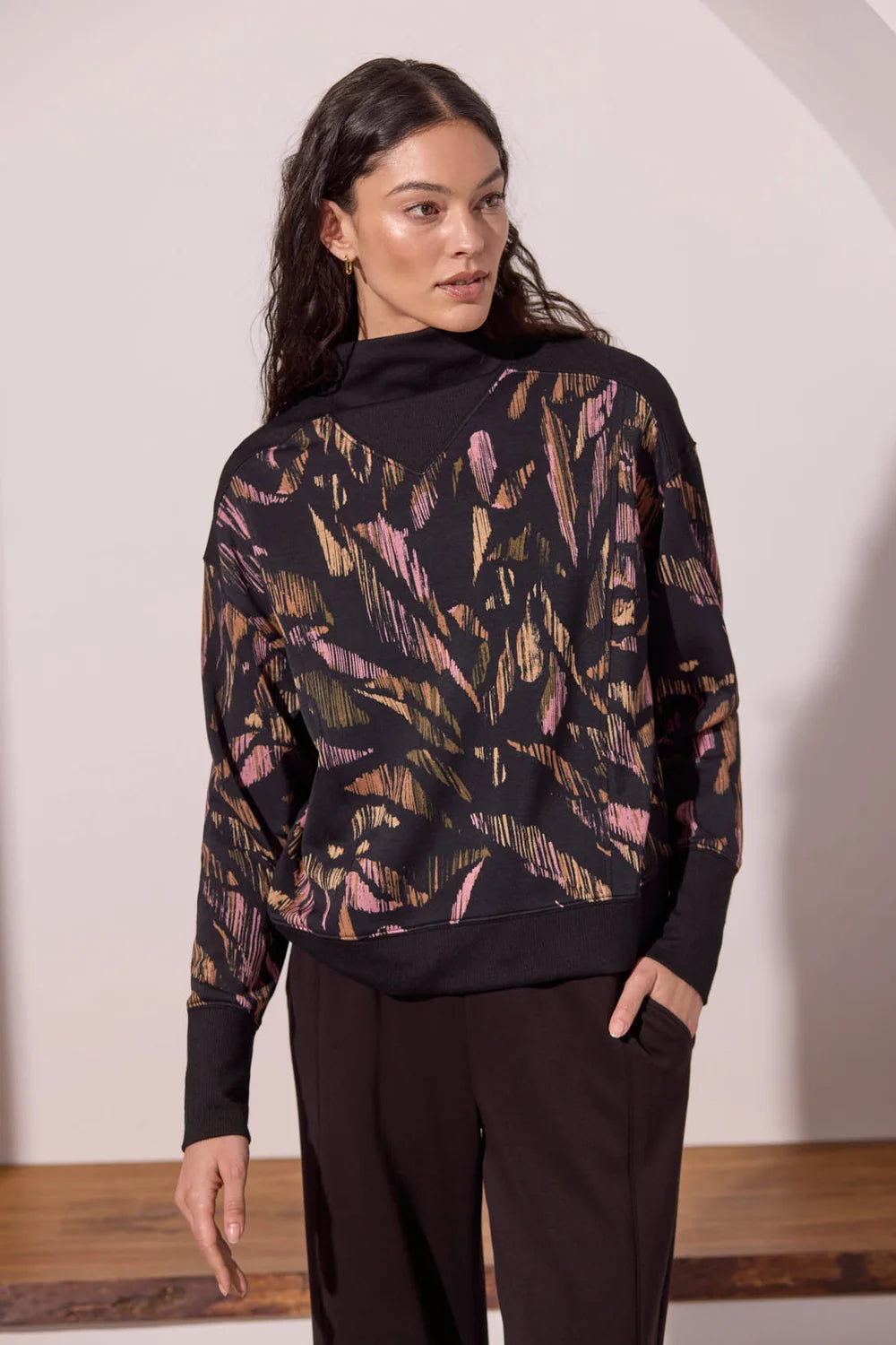 Broderick's Clothing Co. Tribal print long sleeve mock neck top in soft modal blend with black ribbed trim details.