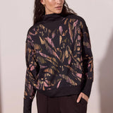 Broderick's Clothing Co. Tribal print long sleeve mock neck top in soft modal blend with black ribbed trim details.