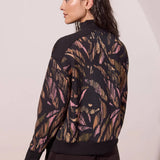 Broderick's Clothing Co. tribal print modal mock neck top with black ribbed trim and long sleeves, back view.