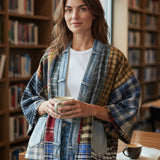 Broderick's Clothing Co. upcycled flannel and denim patchwork cardigan worn by a woman in a library setting.