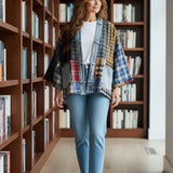 Broderick's Clothing Co. upcycled flannel and denim patchwork cardigan worn by a woman in a library setting.