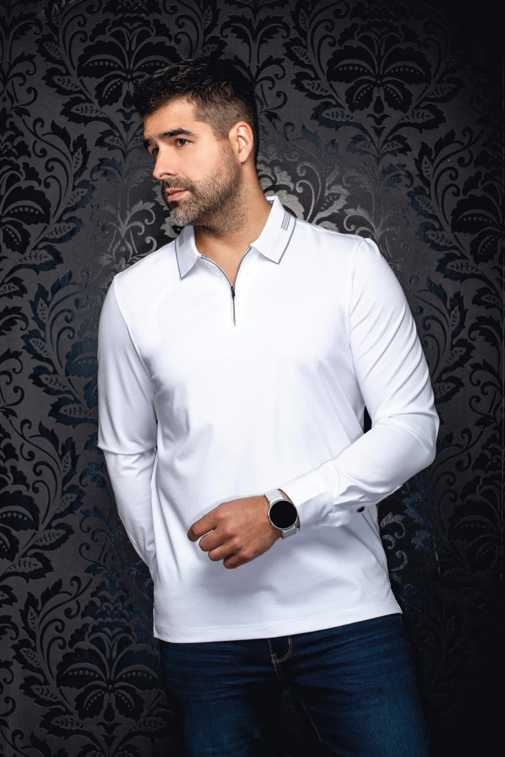 Broderick's Clothing Co. model wearing a white long-sleeve knit polo with a structured collar and zip detail.