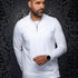 Broderick's Clothing Co. Au Noir white mock neck quarter-zip knit pullover worn by a man against a damask background