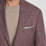 This Midland solid berry blazer is&nbsp;crafted from supersoft and light wool woven in Italy. This fabric allows the wearer to enjoy a crease free linen look thanks to the different colors of yarns used in this 100% worsted wool fabric.