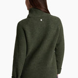Green knitted sweater worn by a person on a white background