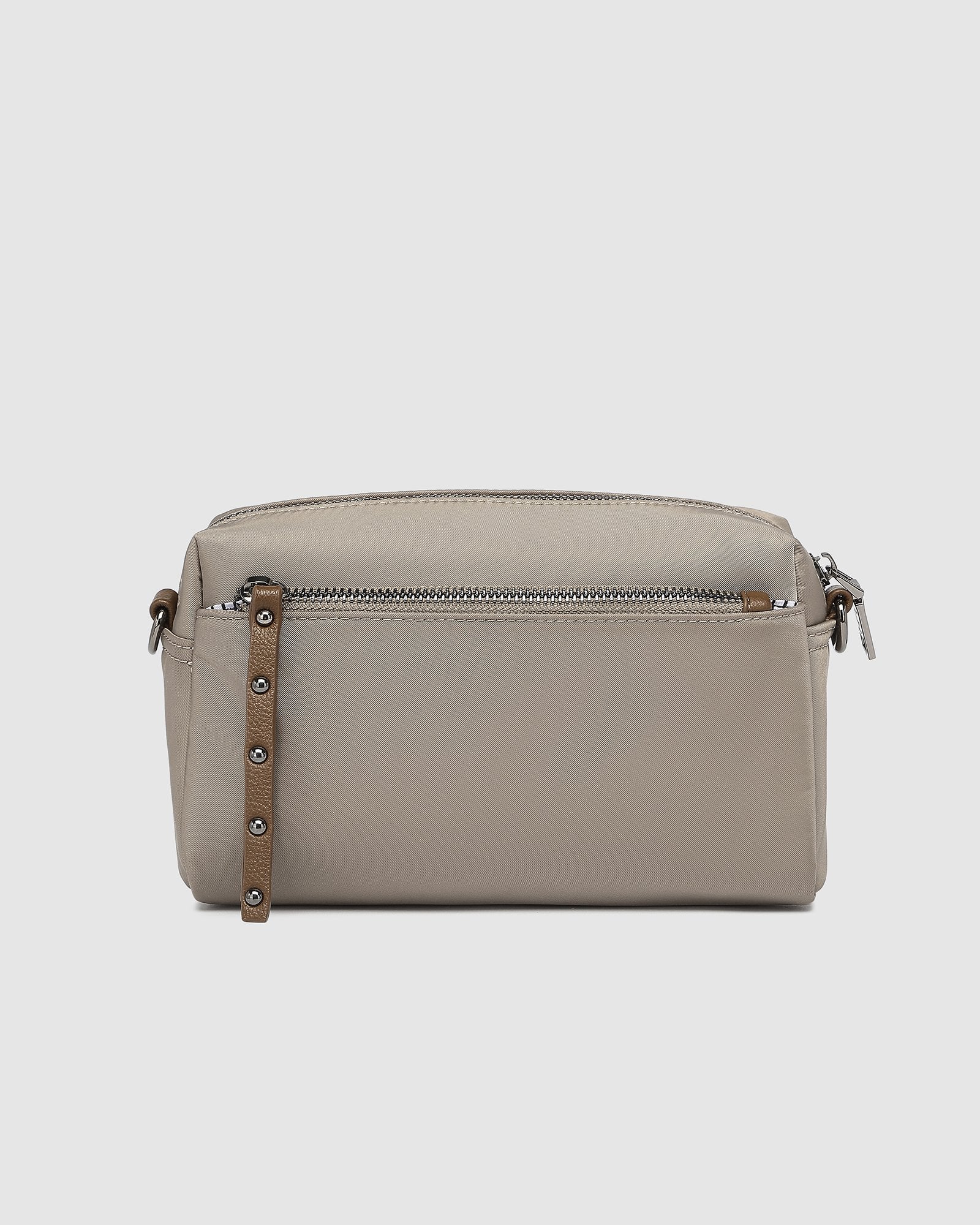 The Louenhide Rowie Nylon Crossbody Bag is the practical, everyday accessory you've been searching for. Embrace an organized dream with multiple internal and external pockets and a stylish matching cardholder. The Rowie's minimalist&nbsp;design is enhanced by the gunmetal detailing - adding the perfect touch of contemporary edge to its classic silhouette.&nbsp; Whether you're exploring the city or embarking on an adventure, this crossbody bag effortlessly complements your capsule wardrobe. 